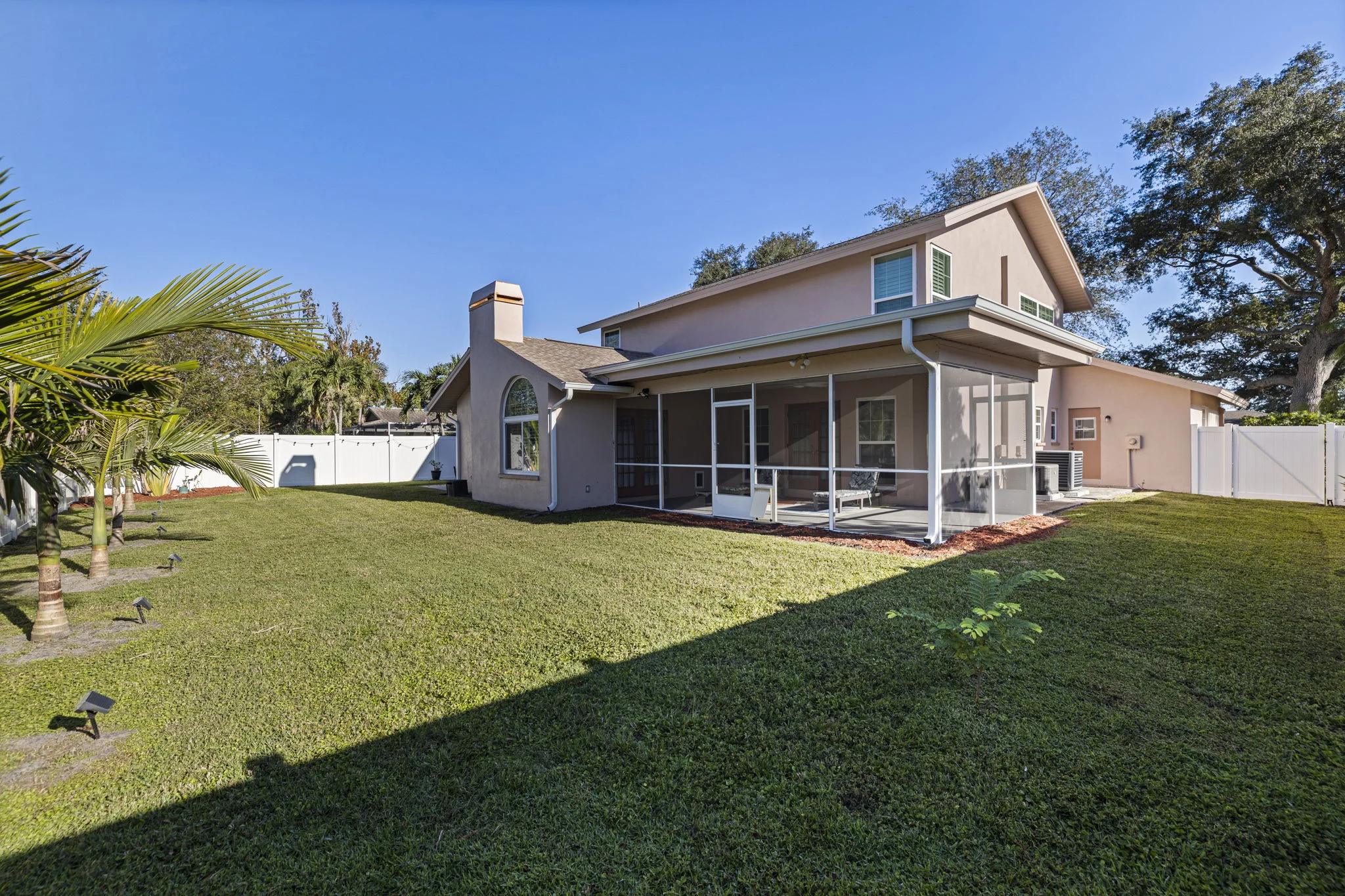 Rear view of the Harwood residence and spacious green lawn